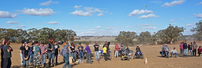 Panorama of crazy people in a dusty paddock