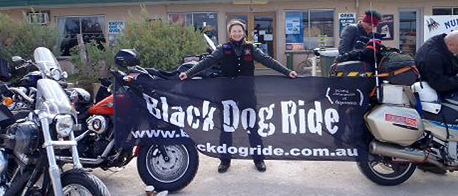 Nic with the Black Dog Ride banner.