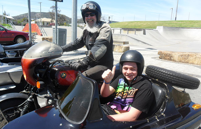 Bob giving a student a lift in his chair.