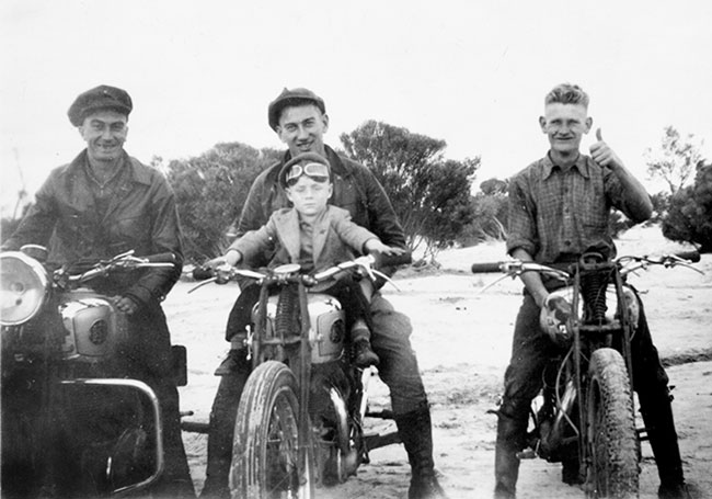 Young Bob Jackson sitting on tank.