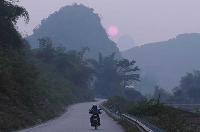 Garry riding back from Ho Chi Minh cave at sunset.