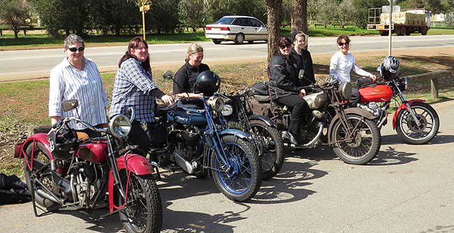 Lady riders and bikes line-up.