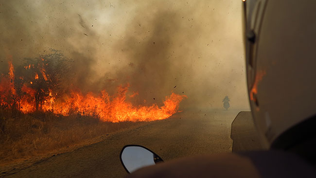 Riding through a bushfire in Zimbabawe.