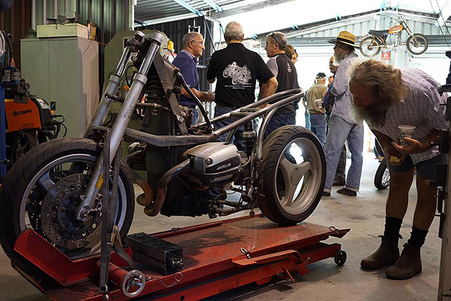 Don inspecting a BMW custom minus bodywork.