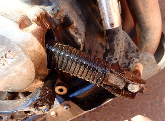 Footrest trying to escape the rough road by hiding in crankcase.