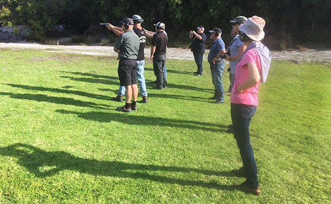 Having a go at pistol shooting.