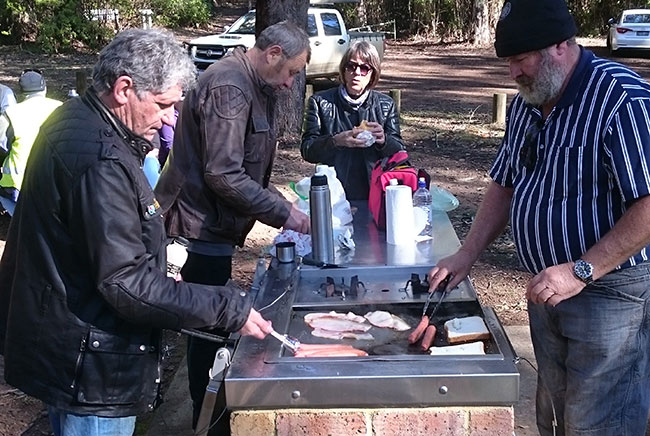 Raelene supervising Paul, Steve and Ross cooking lunch.