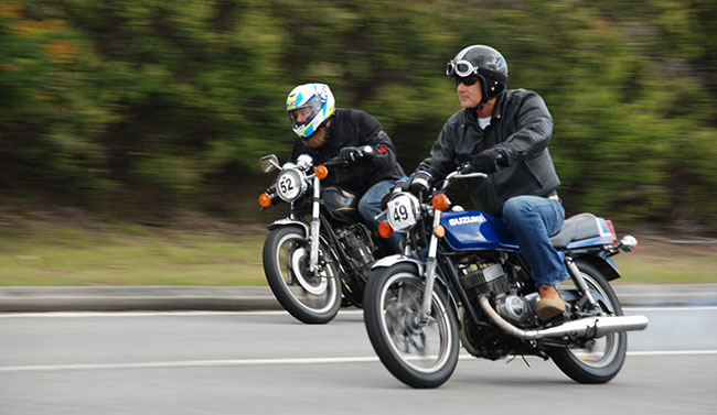 Two riders on 1978 bikes from Suzuki and Yamaha.