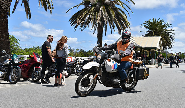 Antoinet takes off on her BMW R80GS.