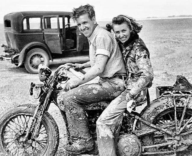 Dirty couple on old bike.