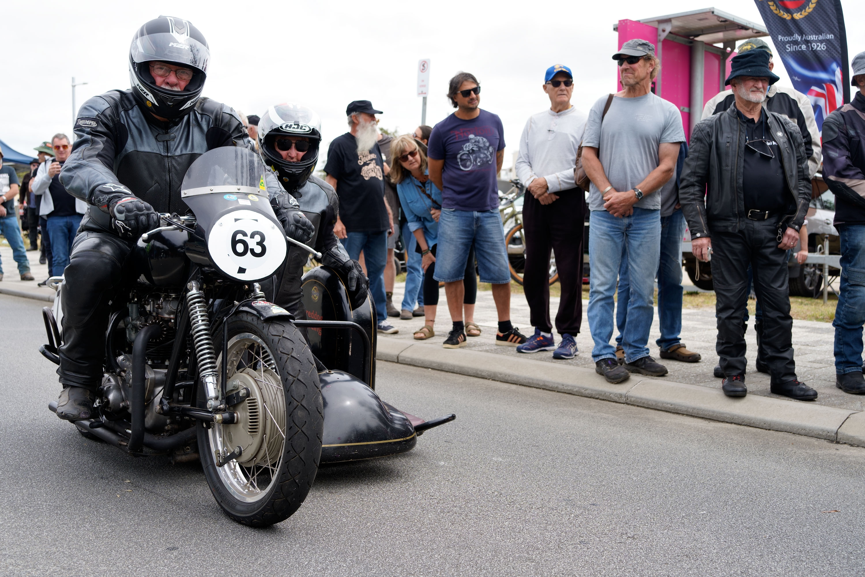 Triumph sidecar rider and swinger ready to go up the hillclimb.
